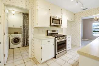 Kitchen looking into laundry